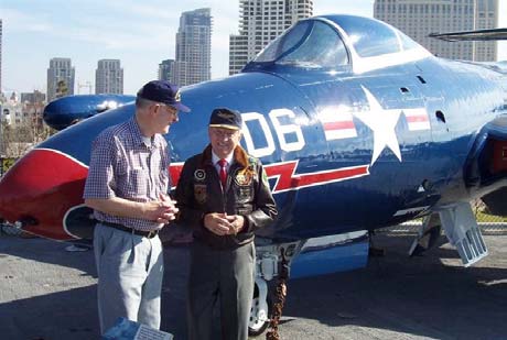 Royce Williams and Ed Bethel, formerly of VF-781, in front of the F9F-5 on the USS Midway in San Diego Harbor, 2005. The F9 is painted in the colors of Royce’s F9 when he shot down 3 MiG-15s 40 miles from Vladivostok 18 November 1952. [His story is on the website.]